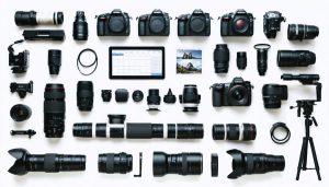 A meticulously arranged display of rented professional photography equipment, including DSLR cameras, lenses, and lighting setups, symbolizing easy access to high-end gear for photographers.