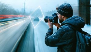 A photographer adjusting camera settings surrounded by scenes showcasing creative uses of manual photography - blurred water, clear portraits, and cityscapes, with an overlay of the exposure triangle.