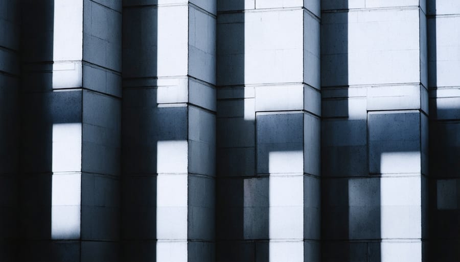 Modern building facade with dramatic shadows and geometric patterns in black and white
