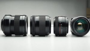 Conceptual illustration depicting the evolution of camera lenses, from vintage single-element designs to complex modern multi-element configurations, highlighting advanced optics technologies.