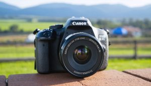 Close-up of a premium Canon camera lens set against a vivid backdrop, illustrating the enhanced image quality and detail that high-quality lenses provide.