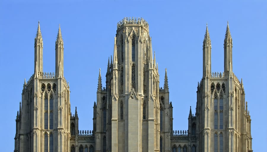 Vertical panorama of a Gothic cathedral's spires reaching into the sky, showcasing intricate architectural details from base to peak.